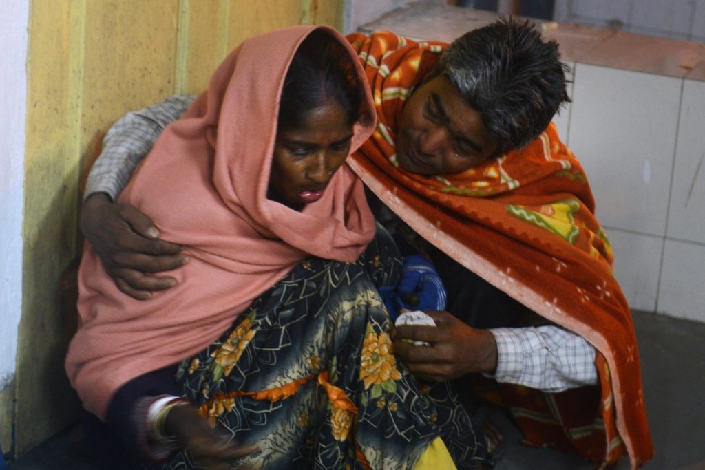  An injured Indian woman is comforted by her husband as she waits for treatment at Siliguri Hospital following an earthquake. Photo: diptendu dutta/Agence France-Presse/Getty Images 